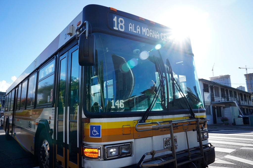 Bus route 18 picks up passengers on Pensacola Street at McKinley High School Thursday, Aug. 15, 2024, in Honolulu. The route will be discontinued. Some regular riders have found a community with each other and the driver. (Kevin Fujii/Civil Beat/2024)