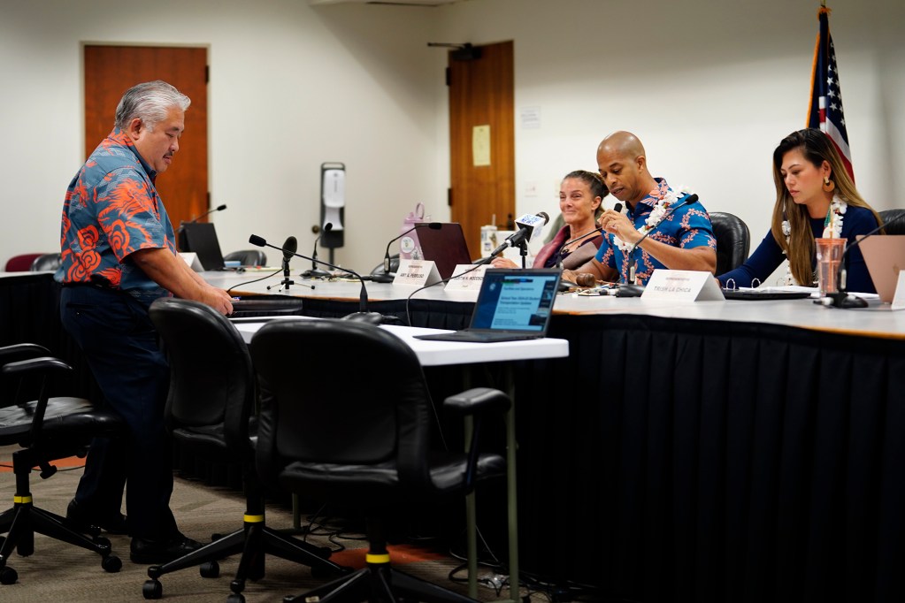 Department of Education Superintendent Keith Hayashi takes a seat in front of Hawaii state House of Representatives Committee on Education member Amy Perruso, Chair Justin Woodson and Vice Chair Trish La Chica before a special Informational Briefing on Thursday, Aug. 15, 2024, in Honolulu. The hearing outside of regular session is to learn about the bus-driver shortage and informing parents with only three days before school began. (Kevin Fujii/Civil Beat/2024)