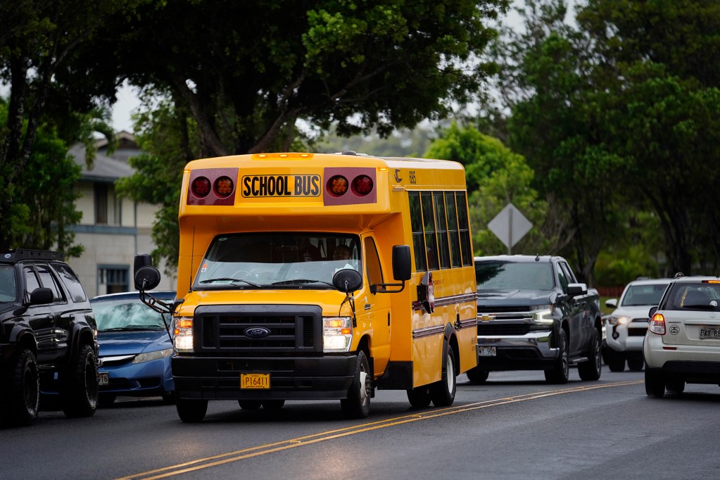 School buses are photographed Monday, Aug. 26, 2024, in Mililani. The Department of Education was criticized for announcing the cancellation of numerous bus routes three days before the 2024 autumn school semester began. (Kevin Fujii/Civil Beat/2024)
