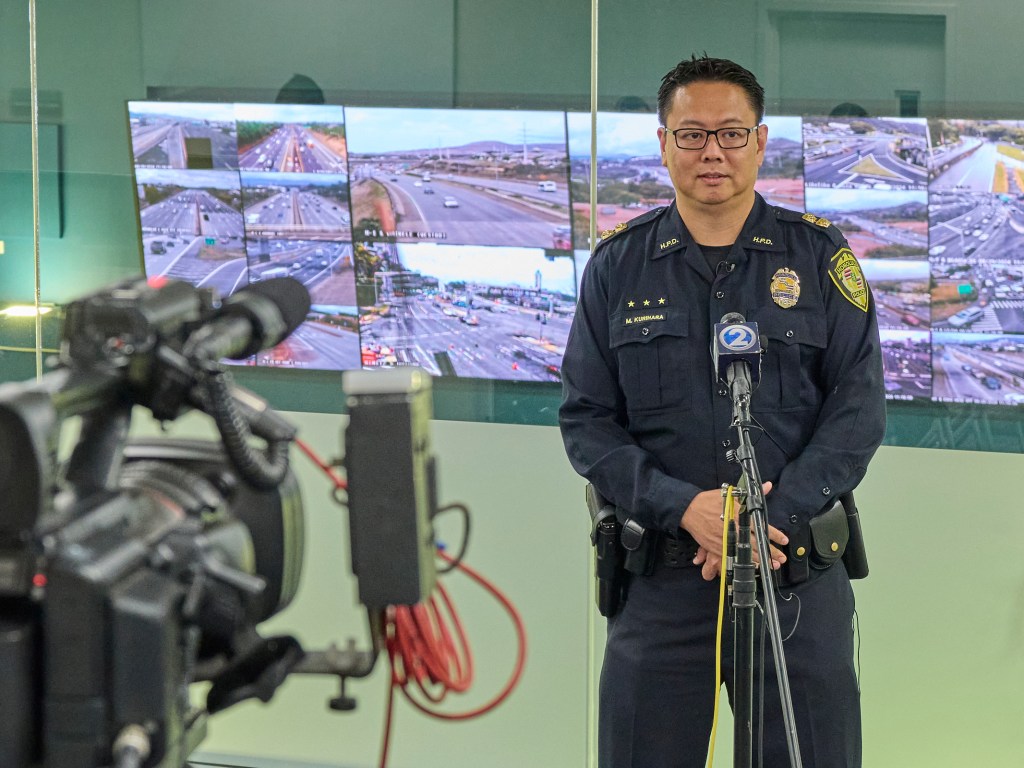 At the Honolulu Joint Traffic Management Center on Thursday August 29th, 2024 Captain Matthew Kurihara of the HPD Communications division shared details of a 911 enhancement that will begin operation on Oahu on September 5th, 2024.  Honolulu 911 system currently receives up to 1 million 911 calls a year. Approx 10-12,000 call a month are abandoned calls or disconnected calls but because of the emergency nature of the call all calls must be followed up on. This new automated system will help to alleviate any backlog within the system.(David Croxford/Civil Beat/2024