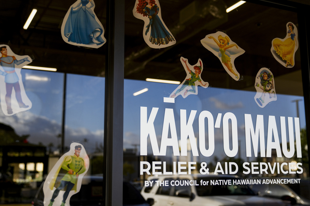 Images of Disney characters are seen on the entrance to the Kako'o Maui Relief & Aid Services Center, run by the Council for Native Hawaiian Advancement, on Wednesday, July 10, 2024, in Kahului, Hawaii. (AP Photo/Lindsey Wasson)
