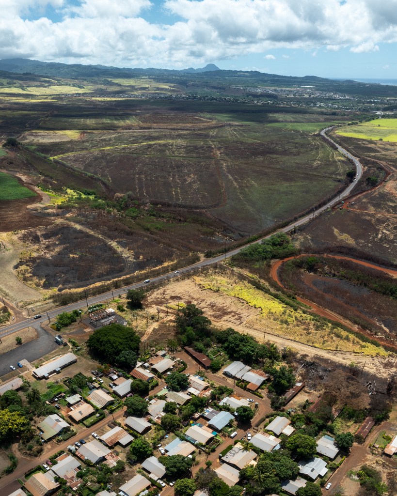 An aerial view of the burn scar left behind after a wildfire scorched over 1000 acres in South Kauai and encroaches on Kaumakani Village.