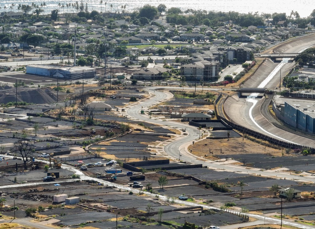 Komo Mai Street wends through Lahaina near the Kahoma Stream channel where hundreds of residential properties have been cleared since the Aug. 8, 2023, fires. This photo was taken in July. (Nathan Eagle/Civil Beat/2024)