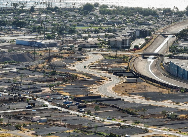 Komo Mai Street wends through Lahaina near the Kahoma Stream channel where hundreds of residential properties have been cleared since the Aug. 8, 2023, fires. This photo was taken in July. (Nathan Eagle/Civil Beat/2024)