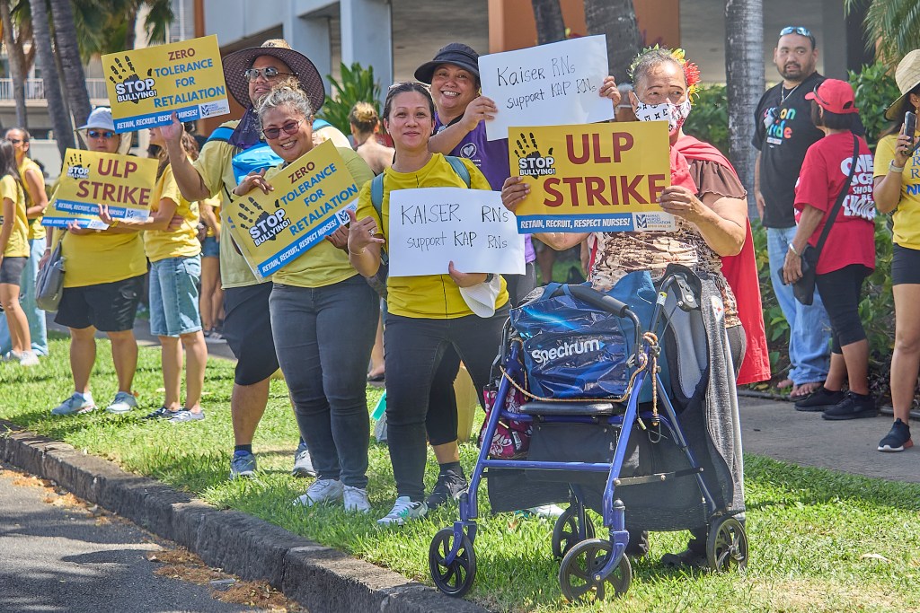Nurses from Kapiolani Medical Center along with small contingents from other unionized hospitals join their colleagues to strike and walk the picket line outside the Kapiolani facility on Punahou Street in Honolulu. The facility threatened that if any nurses stayed away from work on Friday they would not be allowed to return to work following the strike date. (David Croxford/Civil Beat/2024