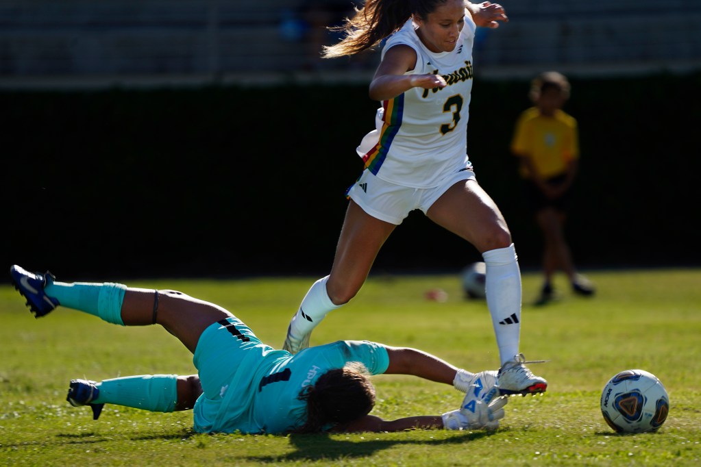 University of Hawaii Wahine midfielder Brynn Mitchell (3) battles for a loose ball against Hawaii Pacific University goal keeper Lauren Retsky (1) Sunday, Sept. 22, 2024, at the Waipio Peninsula Soccer Stadium field in Waipahu. The Rainbow Wahine call this City and County of Honolulu Department of Parks and Recreation stadium their home field. (Kevin Fujii/Civil Beat/2024)