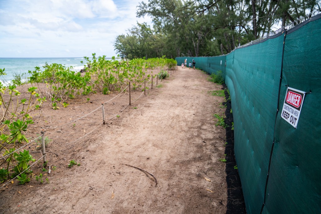 Coastal pathway at Turtle Bay on Oahu's North Shore. Arete Collective and the Wasatch Group plan to develop new residential units on 65-acres of land near the Turtle Bay Resort. The proposed development parcel is behind the green dust fence on the right.