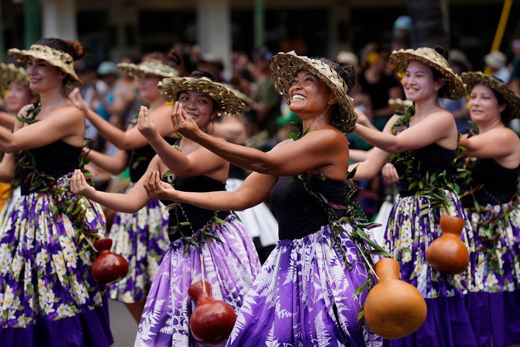 Halau Hula Na Puakea o Koolaupoko performs on the Kalakaua Avenue in the Aloha Festivals 76th Annual Floral Parade Saturday, Sept. 25, 2024, in Honolulu. (Kevin Fujii/Civil Beat/2024)