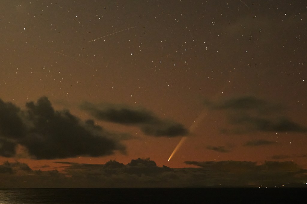Comet a3-tsuchinshan-atlas is making its presence know in the early hours of each morning until October 2nd when it’s better sitings will be had in the evenings from the west side.   These images were shot on the morning of September 29th from the Halona Blowhole between 5:07 and 5:10am.  There is also evidence of other satellites lurking above us as light trails are clearing visible in the 10-15 second exposures used to create the images. (David Croxford/Civil Beat/2024)