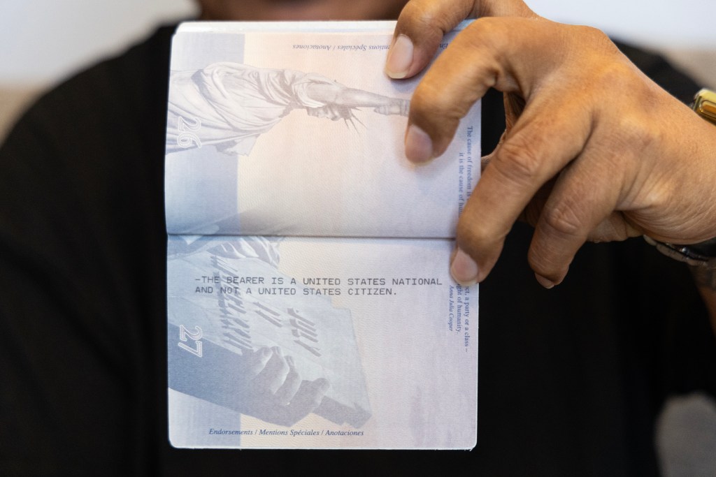 John Fitisemanu holds his passport, which has a unique stamp identifying him as a U.S. national, on Tuesday, June 18, 2024, at his home in Woods Cross, Utah. While those born in other territories are automatically U.S. citizens, American Samoans are not. (Photo by Christopher Lomahquahu/News21)