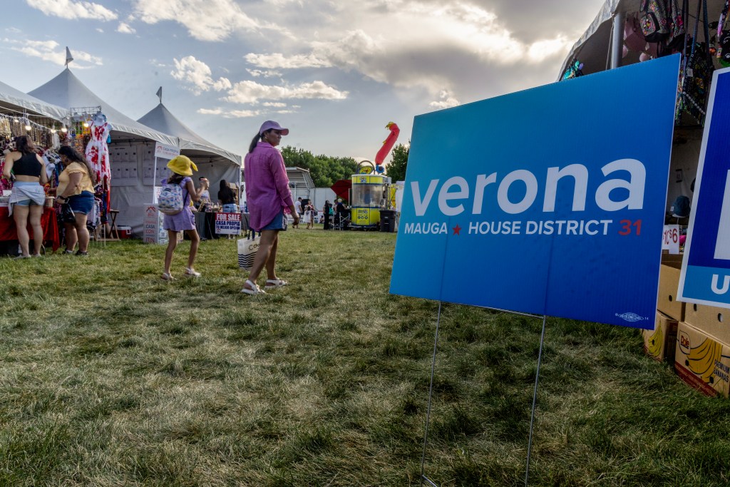 Campaign signs at WestFest in West Valley City, Utah, on Friday June 14, 2024, promote Verona Mauga’s run for the Utah House. Mauga, a first-generation American, says she would be the first Samoan woman in any state legislature in the continental U.S. if elected. (Photo by Christopher Lomahquahu/News21)