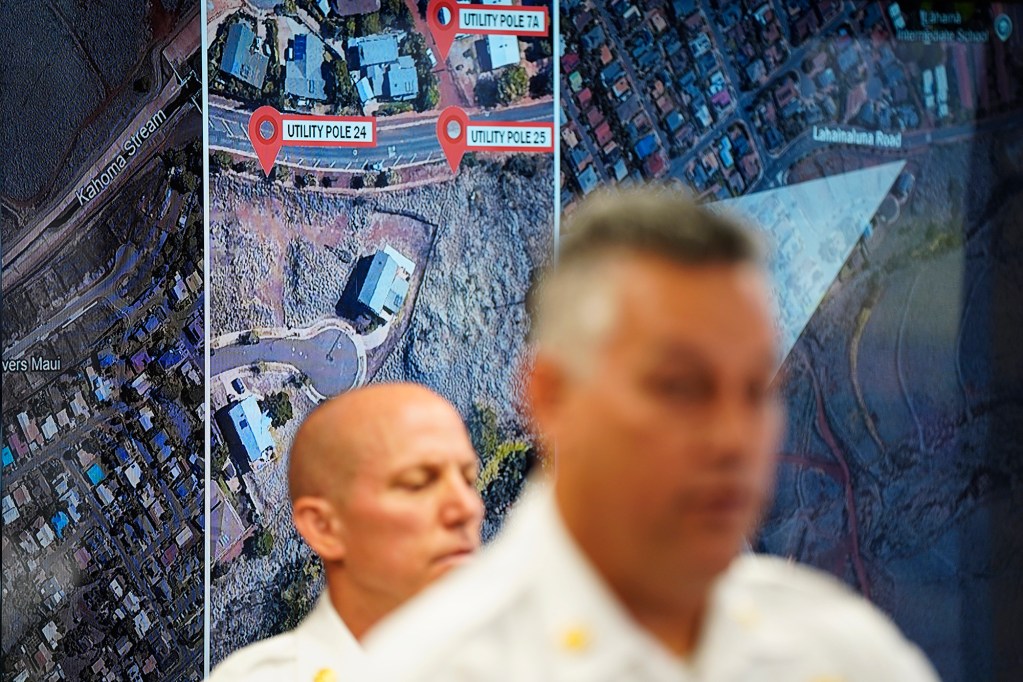 A map from the ATF report shows where the Aug. 8, 2023, fire started and re-ignited behind Maui County Department of Fire and Public Safety (MFD) Assistant Chief Jeffrey Giesea, left, and Chief Brad Ventura Wednesday, Oct. 2, 2024, in Wailuku. This fire destroyed the town of Lahaina and killed 102 people. The area of ignition is mauka of the Lahaina Bypass and immediately south of Lahainaluna Road. (Kevin Fujii/Civil Beat/2024)