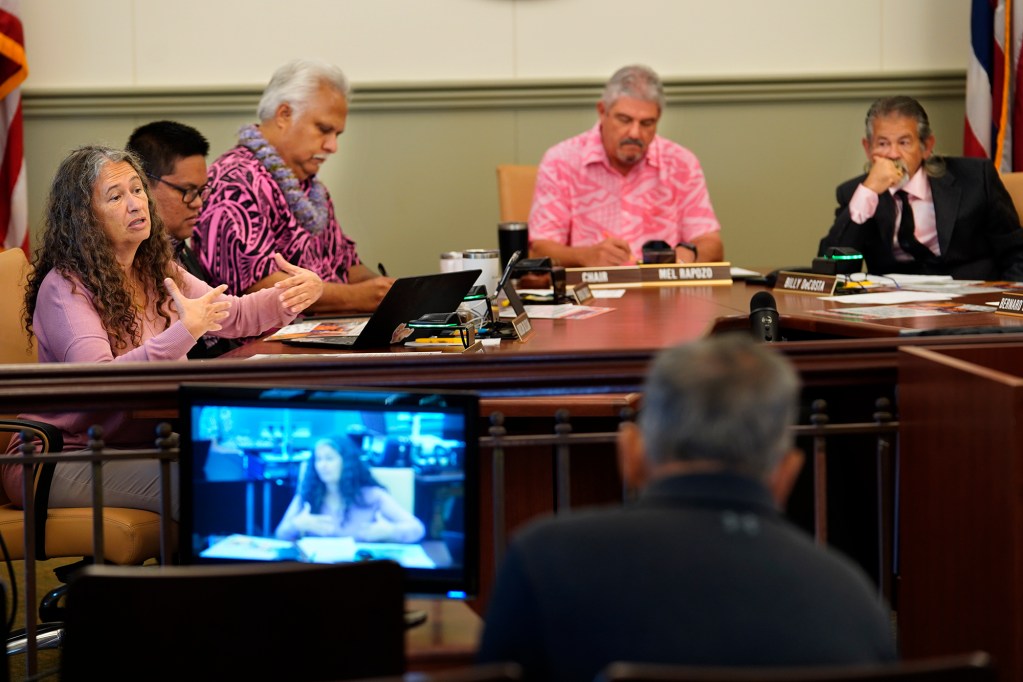 Kauai County Council member Felicia Cowden, left, speaks to the organizers of the 11th Annual Harvest Festival while Addison Bulosan, Vice Chair KipuKai Kuali’i, Chair Mel Rapozo and Bill DeCosta look on during their meeting Wednesday, Oct. 9, 2024, in Lihue. (Kevin Fujii/Civil Beat/2024)