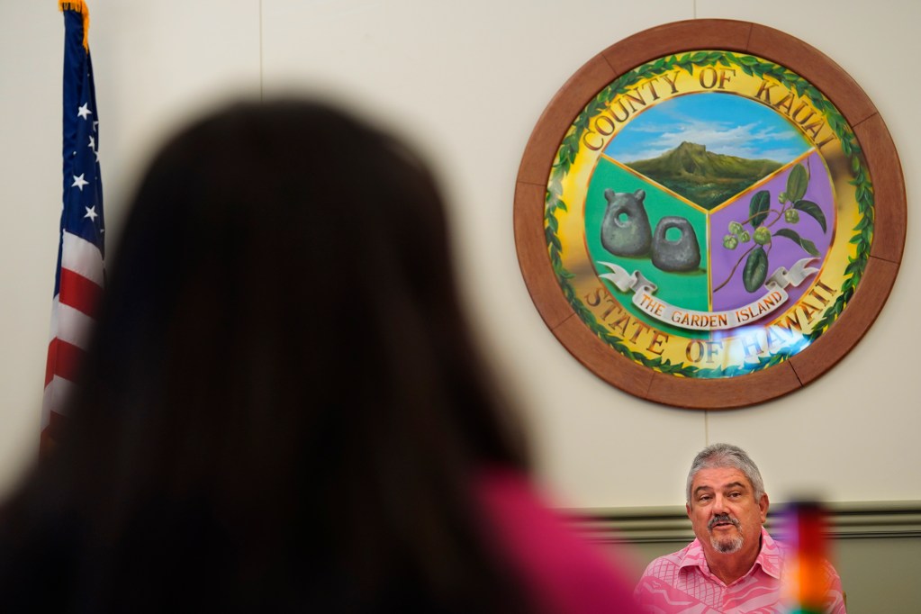 Kauai Council Chair Mel Rapozo comments to those being honored with a proclamation Wednesday, Oct. 9, 2024, in Lihue. Council members Bill DeCosta, middle, and Bernard Carvalho, Jr., look on. (Kevin Fujii/Civil Beat/2024)