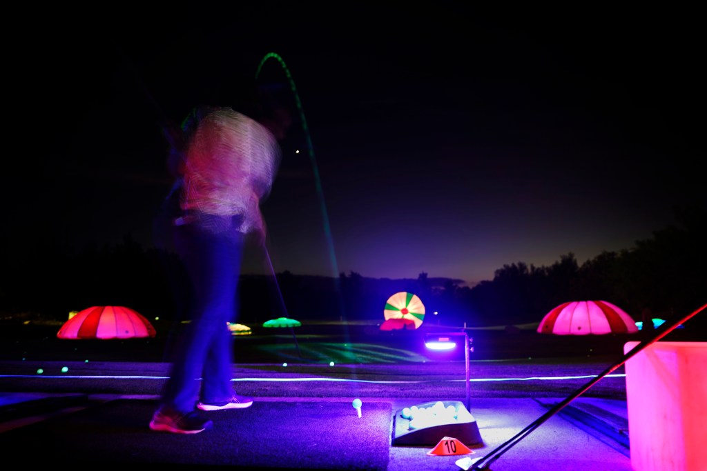 The Hawaii Prince Golf Club’s driving range becomes a disco party with Cosmic Drive’s glow-in-the-dark golf balls and illuminated targets Friday, Oct. 18, 2024, in Ewa Beach. Generally Cosmic Drive is held on Friday and Saturday nights once a month. This month’s theme was Halloween. Best for the short game, targets are within 130 yards. (Kevin Fujii/Civil Beat/2024)