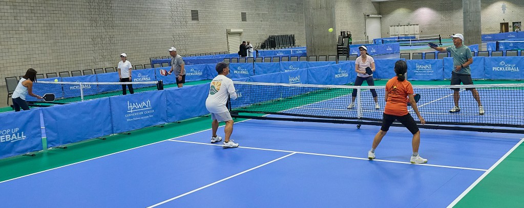 The Hawaii Convention Center has officially welcomed the Pickleball world into its venue with the opening of 45 new courts. During the weekend of November 1 through 3 the Inaugural Aloha Pickleball Games and Festival will be hosting 560 registered amateur players. The opening blessing and court try outs were photographed October 30, 2024(David Croxford/Civil Beat/2024)