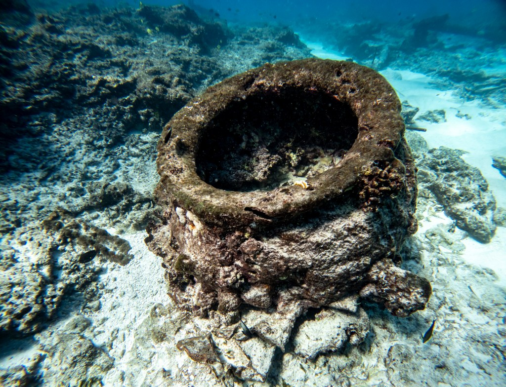 A huge iron pot, used by a 19th century British whaling ship called the Pearl, was used to boil down whale blubber to make liquid oil. The ship ran aground at Manawai, which became known as the Pearl and Hermes Reef. The Hermes also ran aground nearby. (Nathan Eagle/Civil Beat/2024)