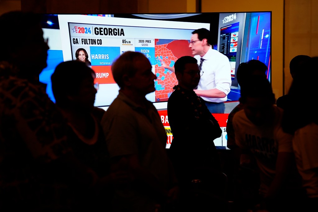 Results are broadcast as Democrats gather on election night Tuesday, Nov. 5, 2024, in Honolulu. (Kevin Fujii/Civil Beat/2024)