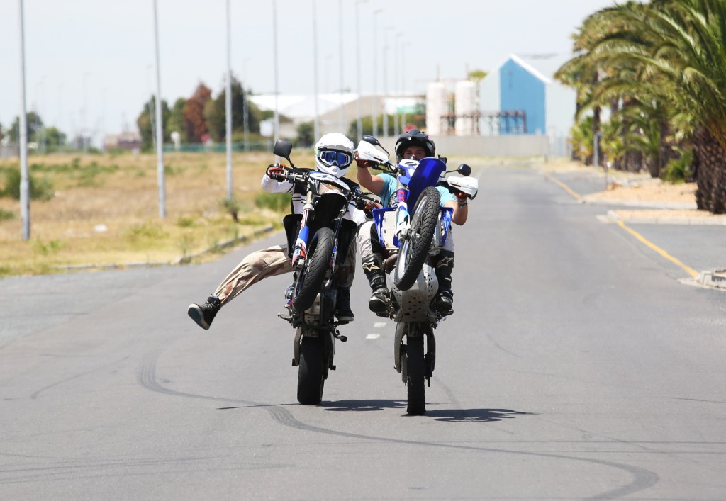 Cape Town, South Africa, January 21, 2018: Motorbike riders from the club “Cape Town Supermotard Street Legal” practice their stunts in a public road.
