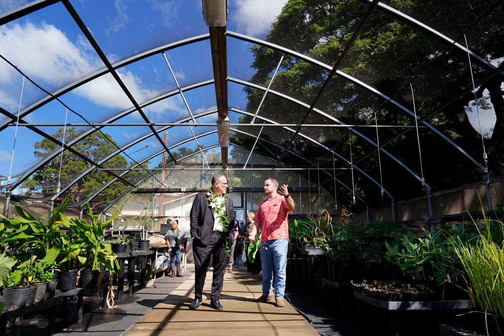 U.S. Department of Education Sec. Miguel Cardona chats with Nathan Pallett, the coordinator of the Agriculture Learning Center Friday, Dec. 6, 2024, in Lahaina. (Kevin Fujii/Civil Beat/2024)