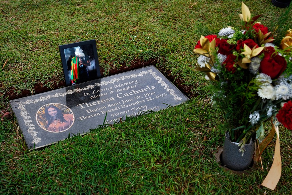 Theresa Cachuela’s grave is photographed Sunday, Dec. 15, 2024, at the Mililani Memorial Park and Mortuary in Mililani. Theresa was killed almost one year ago by her estranged husband Jason Cachuela despite a temporary restraining order. Jason was found dead from a self-inflicted gunshot wound shortly after he fled the murder scene. (Kevin Fujii/Civil Beat/2024)