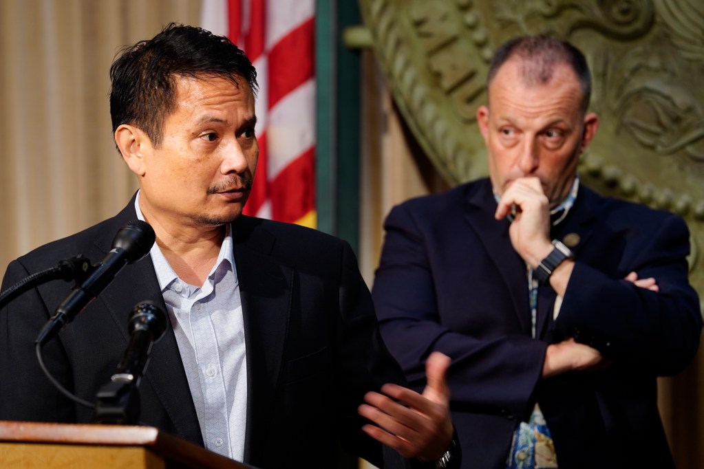Director of Budget and Finance Luis Salaveria speaks ask Gov. Josh Green looks on during the news briefing for the Executive Biennium Budget for Fiscal Years 2025-2027 to the Legislature Monday, Dec. 16, 2024, in Honolulu. (Kevin Fujii/Civil Beat/2024)