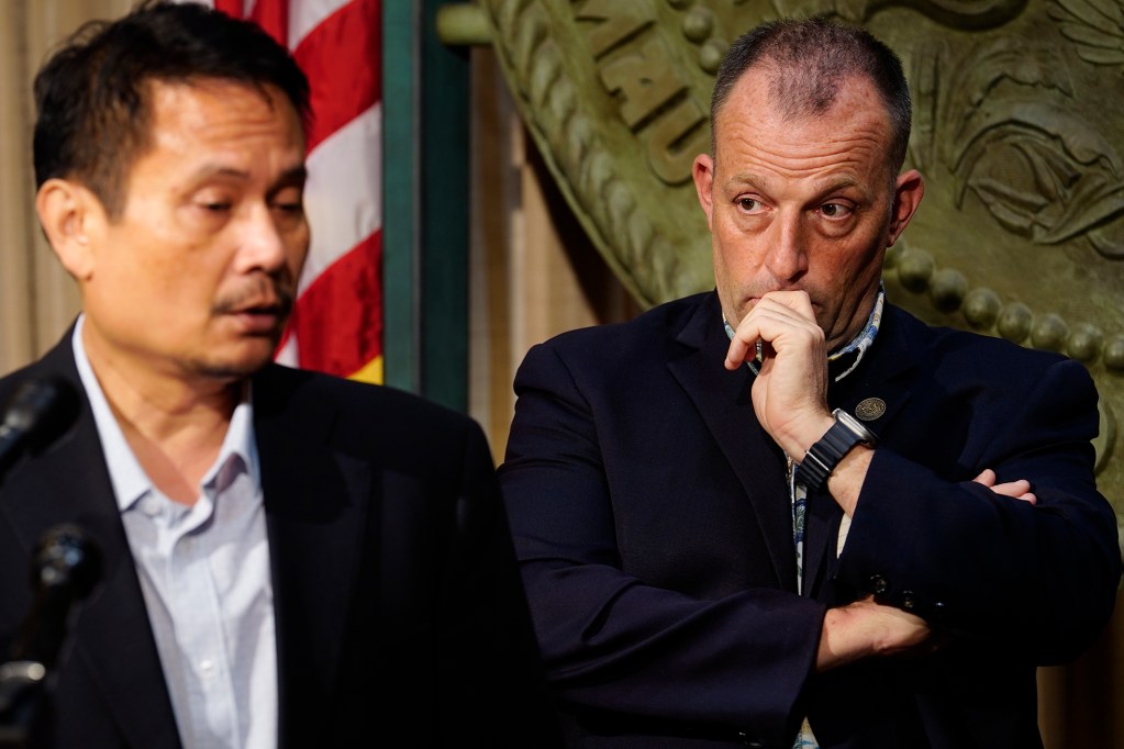 Gov. Josh Green looks toward Director of Budget and Finance Luis Salaveria during the news briefing for the Executive Biennium Budget for Fiscal Years 2025-2027 to the Legislature Monday, Dec. 16, 2024, in Honolulu. (Kevin Fujii/Civil Beat/2024)