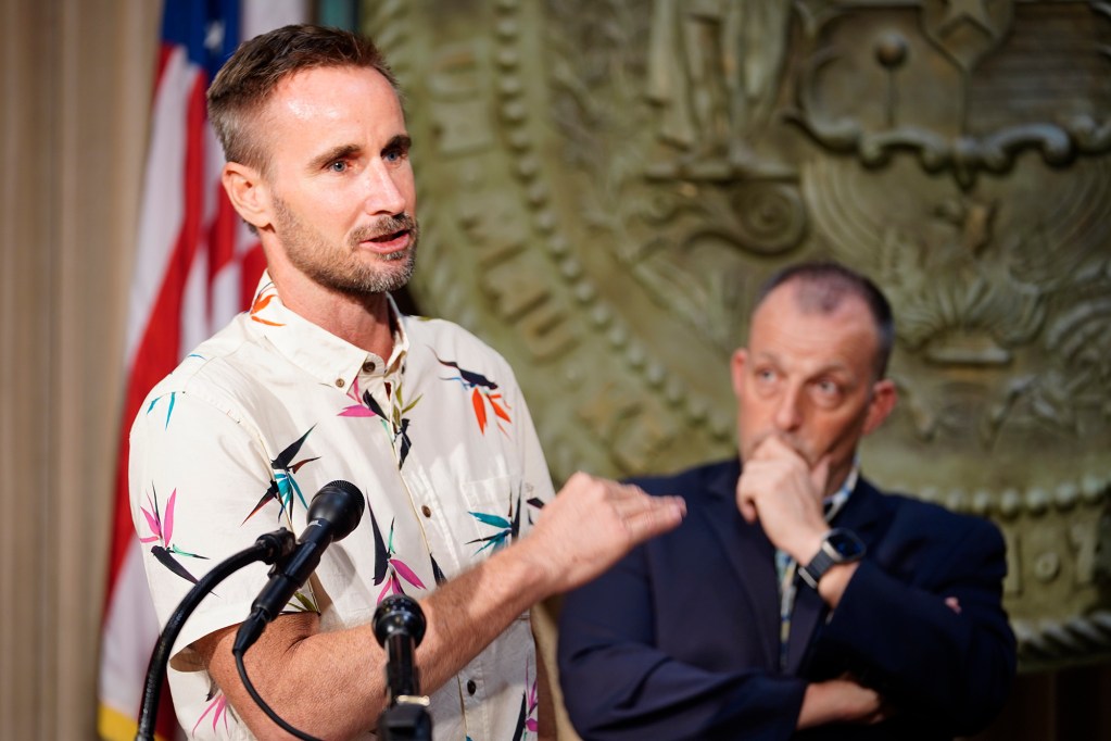 Seth Colby, DOTAX Tax Research and Planning Officer, answers a question as Gov. Josh Green looks on during the news briefing for the Executive Biennium Budget for Fiscal Years 2025-2027 to the Legislature Monday, Dec. 16, 2024, in Honolulu. (Kevin Fujii/Civil Beat/2024)