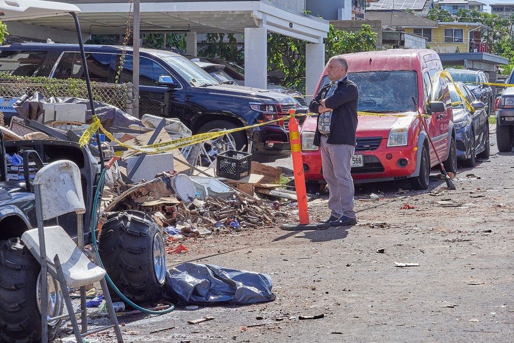 The tragic toll of illegal aerial fireworks shown at the site of 4144 Keaka Drive.  Gov. Josh Green toured the area with Police and other personnel on New Years morning and held an impromptu press conference at the scene confirming that two people had died at the scene with multiple others being transported to local hospitals and two of those, including a child, in life threatening situations.(David Croxford/Civil Beat/2024)