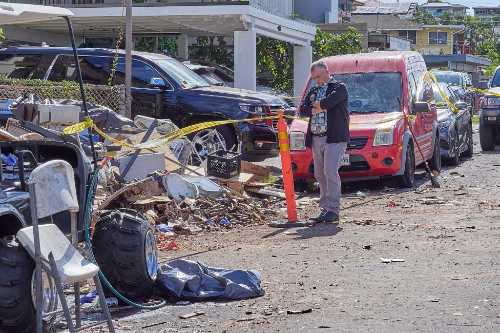 The tragic toll of illegal aerial fireworks shown at the site of 4144 Keaka Drive.  Gov. Josh Green toured the area with Police and other personnel on New Years morning and held an impromptu press conference at the scene confirming that two people had died at the scene with multiple others being transported to local hospitals and two of those, including a child, in life threatening situations.(David Croxford/Civil Beat/2024)