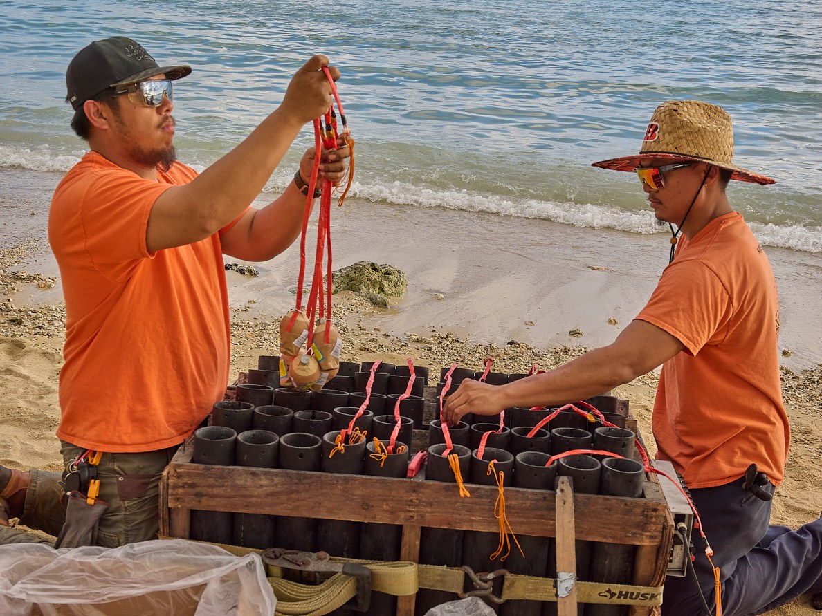 On most Friday nights in the Waikiki, Honolulu, Magic Island area, visitors and locals alike can watch a 5 minute fireworks show sponsored by Hilton Hawaii Hotel and put on by Hawaii Explosives and Pyrotechnics,Inc. The show lasts between 4 and 5 minutes but the preparation and set up can last from 2-3 hours and cleanup another 2.5 hours. The crew has as many as 11 individuals and includes as many as 4 Certified and Licensed Pyrotechnics Technicians who set up each area according to the plan from the Display designer. All the Fireworks are wired into junction boxes that are hardwired to control panels and linked to the firing position up to 100yds away. Photographed January 17th, 2025.(David Croxford/Civil Beat/2025)
