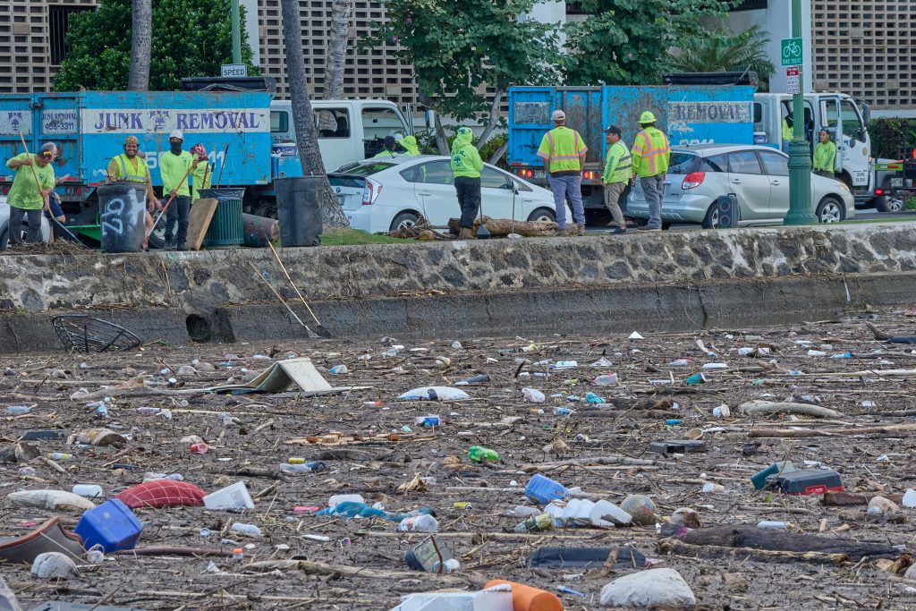 Following the torrential downpours and passage of several Thunderstorms on January 26th much of the stream debris and countless forms of homeless encampments found their way through the various vallies to the Ala War Canal where the miscellaneous junk gathered in front of the Lokahi Canoe ClubÕs site. City and County of Honolulu workers accompanied by other private agencies attempted to remove the material but there remained still a lot of clearing to do in the face of an incoming low level storm expected over Wednesday and Thursday.(David Croxford/Civil Beat/2025)