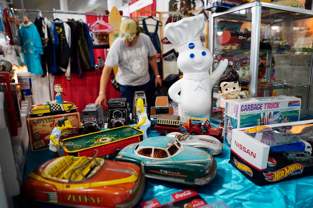Masa Iwata helps set up his friend’s M1 Toy’s booth at the 34th annual Hawaiʻi Collectors Expo at the Neal Blaisdell Center Friday, Feb. 21, 2025, in Honolulu. Iwata is known in the Japanese Toy collector’s group for his former Waikīkī shop SPARK. This three-day event features vendors who collect everything from anime to vintage European decorations.  (Kevin Fujii/Civil Beat/2025)