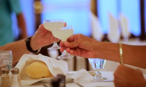 Patrons toast with the featured cocktail of the day, a lemon drop, during a lunch seating at Antoine's Restaurant in New Orleans, Friday, Sept. 11, 2015. The restaurant last year reached its pre-Katrina sales of about $10 million. Next week it will hold a series of events to celebrate its 175th anniversary. The highlights include a visiting chef from Delmonicos in New York who will team up with Antoines Chef Mike Regua to offer special menus, a block party with a brass band and a Prohibition-themed gala. (AP Photo/Gerald Herbert)