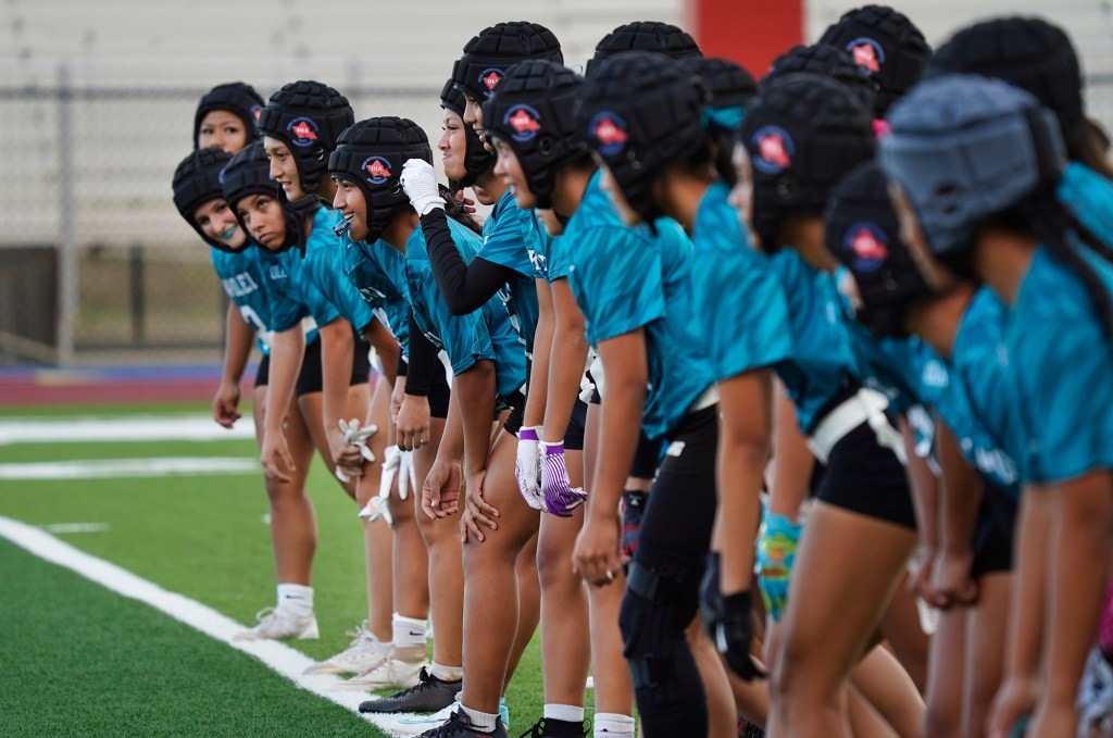 Joyful smiles spread across Kapolei High School girls flag football players faces even for running sprints before taking on Dreamhouse Nā Hōkū in the first Hawai’i girls high school flag football game Tuesday, March 25, 2025, at Wai’anae High School in Wai’anae. (Kevin Fujii/Civil Beat/2025)