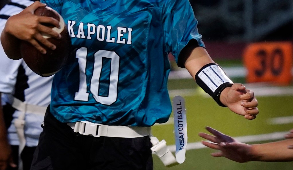 Kapolei’s Lily Tavale’s flag remains out of reach for Dreamhouse Nā Hōkū’s Meiana Chong during the first Hawai’i high school girls flag football game Tuesday, March 25, 2025, at Wai’anae High School in Wai’anae. (Kevin Fujii/Civil Beat/2025)