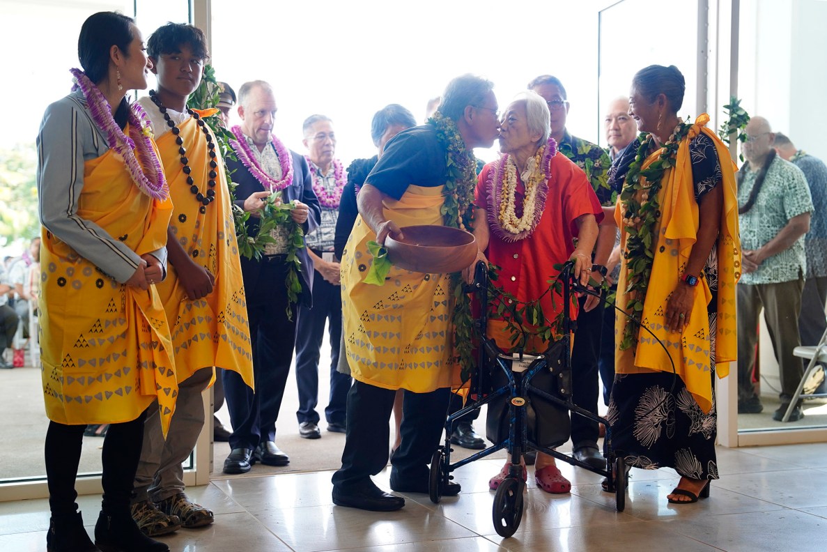 Danny Kahikina Akaka, Jr., kisses his mother Millie Akaka, the widow of the late Sen. Daniel K. Akaka, Wednesday, March 26, 2025, in Kapolei. The blessing officially opens the Daniel K. Akaka State Veterans Home. (Kevin Fujii/Civil Beat/2025)