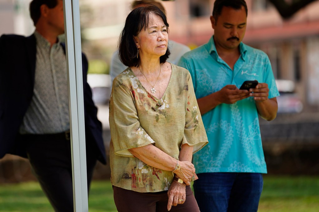 Executive Director of the Institute for Human Services Connie Mitchell listens during Mayor Rick Blangiardi’s news briefing asking for more homeless advocates Tuesday, April 15, 2025, at A’ala Park in Honolulu. (Kevin Fujii/Civil Beat/2025)