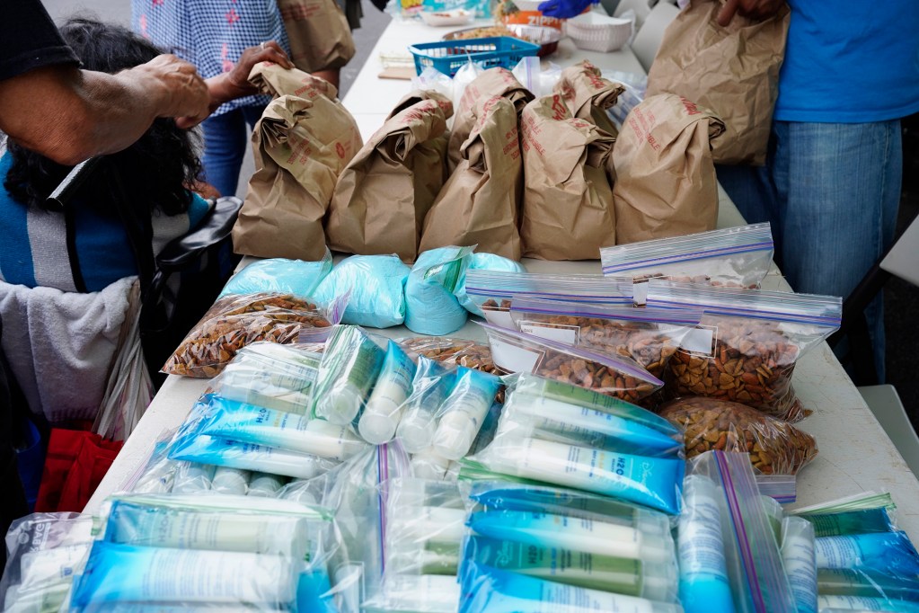 RYSE gives out pet food, toiletries, laundry detergent, meals and a drink at Pūnawai Rest Stop Friday, April 25, 2025, in Honolulu. (Kevin Fujii/Civil Beat/2025)