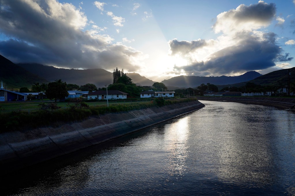 Kaupuni Stream flows into Pōkaʻī Bay Friday, May 2, 2025, in Waiʻanae. Carmen Guzman-Simpliciano’s son experienced a recurring bout of MRSA she believes came from cesspools draining into Kaupuni Stream and into the bay. (Kevin Fujii/Civil Beat/2025)