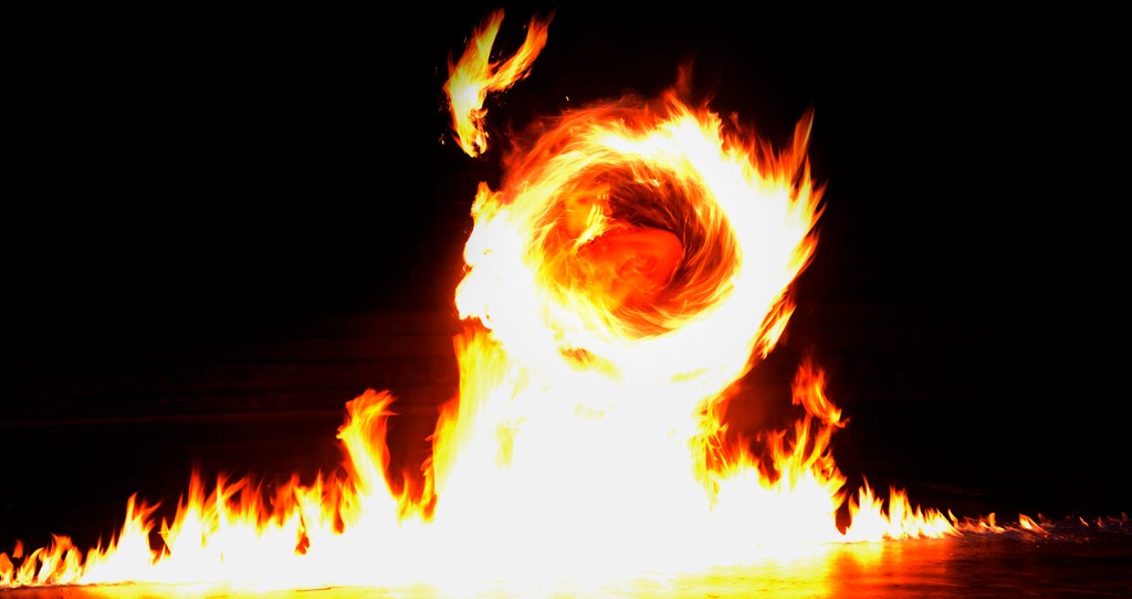 Achiles Tafiti of Lā’ie creates a line of fire during a spin of his single knife during the 2025 World Fireknife Championships take place at the Polynesian Culture Center Wednesday, May 14, 2025, in Lā’ie. (Kevin Fujii/Civil Beat/2025)