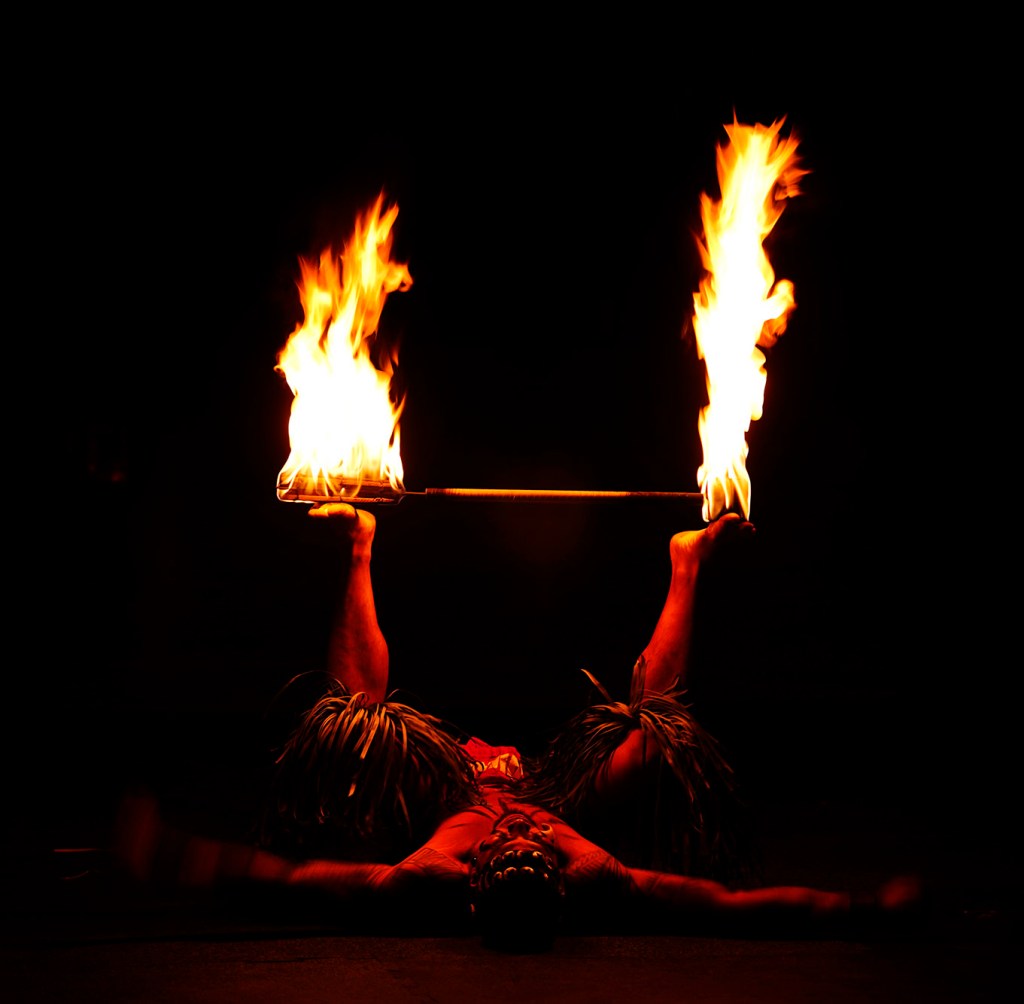 Achiles Tafiti, of Lā’ie, places his single knife on the soles of his feet during the 2025 World Fireknife Championships take place at the Polynesian Culture Center Wednesday, May 14, 2025, in Lā’ie. (Kevin Fujii/Civil Beat/2025)