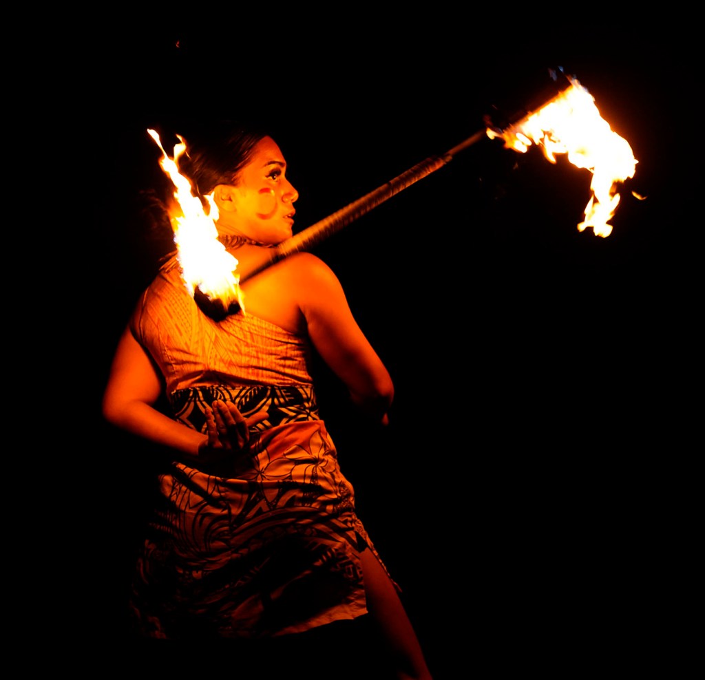 Aaliyah Ava of Laie throws her single knife behind her back during her routine at the 2025 World Fireknife Championships at the Polynesian Culture Center Wednesday, May 14, 2025, in Lā’ie. Ava finished second. (Kevin Fujii/Civil Beat/2025)