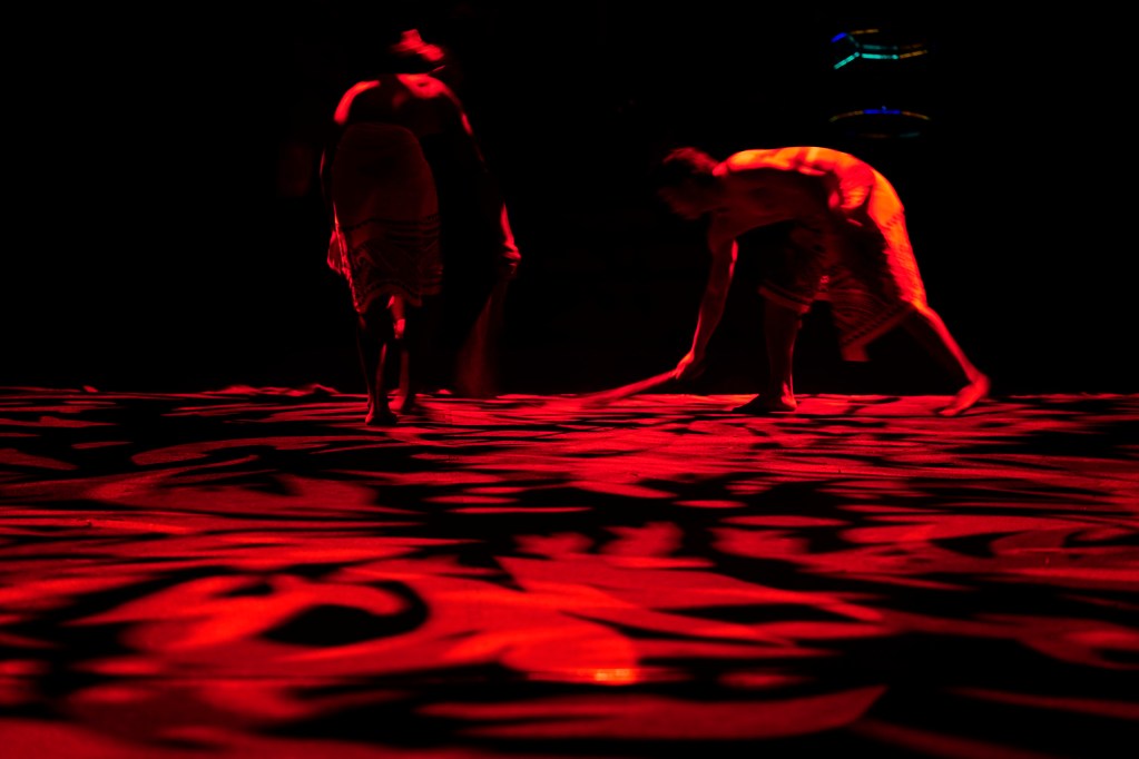 Stage hands sweep sand off the 2025 World Fireknife Championships stage at the Polynesian Culture Center Wednesday, May 14, 2025, in Lā’ie. (Kevin Fujii/Civil Beat/2025)