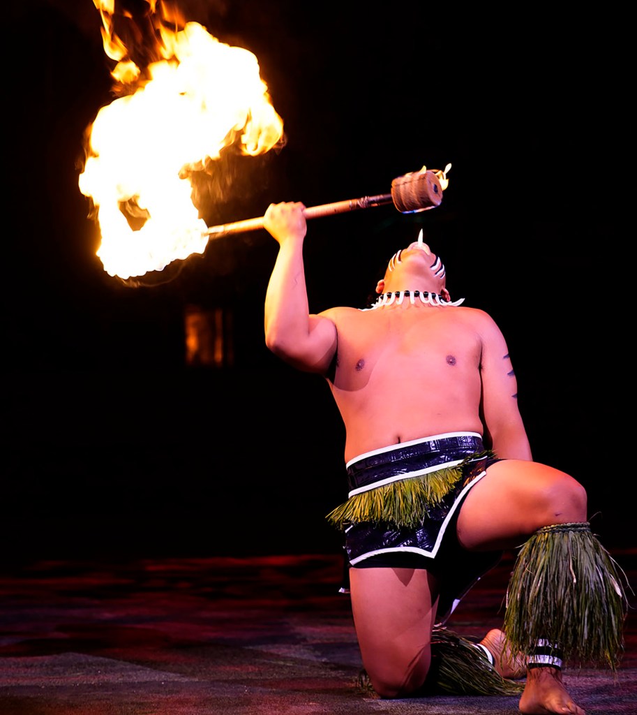 Mose Lilo of ʻEwa Beach ignites a side of his single knife with his mouth during the 2025 World Fireknife Championships at the Polynesian Culture Center Wednesday, May 14, 2025, in Lā’ie. (Kevin Fujii/Civil Beat/2025)
