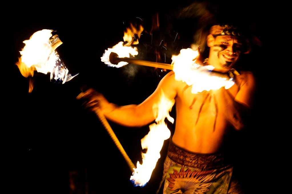 Brandonlee Lavatai of Pago Pago, America Samoa, winces during his 2025 World Fireknife Championships double-knife routine at the Polynesian Culture Center Wednesday, May 14, 2025, in Lā’ie. (Kevin Fujii/Civil Beat/2025)