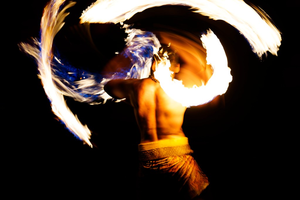 Joseph Cadousteau, of Papeete, Tahiti, performs his double-knife routine in the 2025 World Fireknife Championships at the Polynesian Culture Center Wednesday, May 14, 2025, in Lā’ie. (Kevin Fujii/Civil Beat/2025)