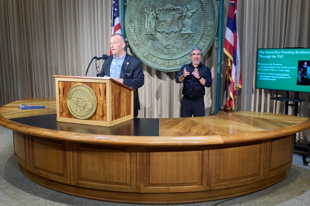 Hawaii Governor Josh Green signed a first in the Nation climate bill that initiates a 0.75% fee upon tourist spending in Hawaii(David Croxford/Civil Beat/2025)