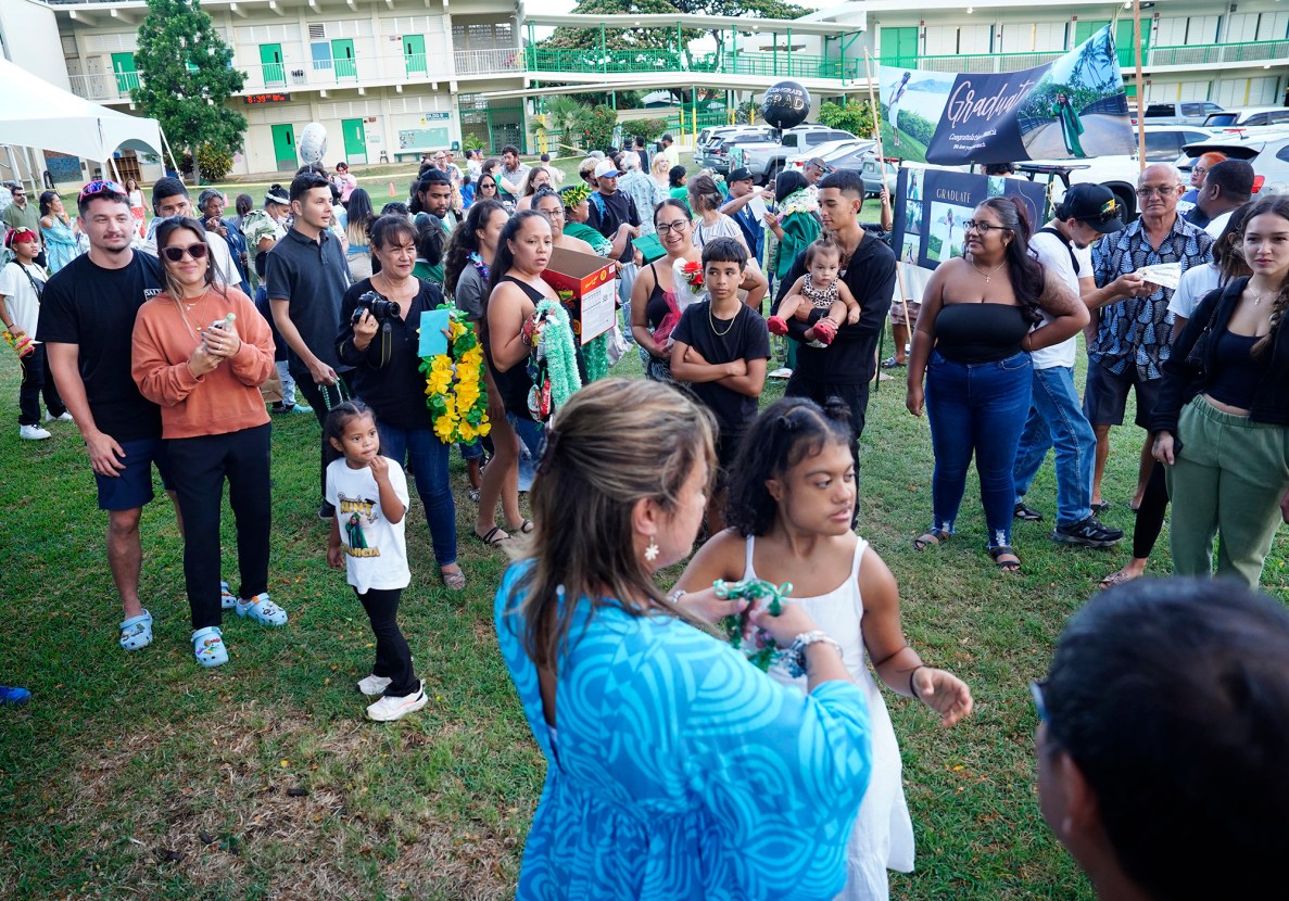Family and friends surround Hawaiʻi School for the Deaf and Blind graduate Kaiyah Ann Pacleb after the graduation ceremony Wednesday, May 28, 2025, in Honolulu. (Kevin Fujii/Civil Beat/2025)