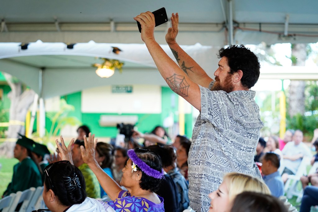 Koa Radl applauds for his daughter Tessie Radl during the Hawaiʻi School for the Deaf and Blind graduation ceremony Wednesday, May 28, 2025, in Honolulu. Tessie boards at the school during the week and commutes home to the Big Island on the weekends. (Kevin Fujii/Civil Beat/2025)